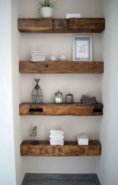 some shelves in a bathroom with towels and candles