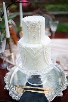 a wedding cake sitting on top of a glass plate