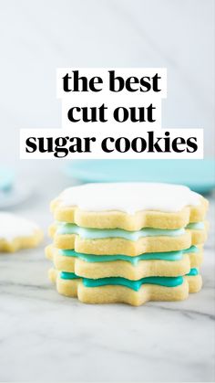 a stack of cookies sitting on top of a table next to blue plates and bowls