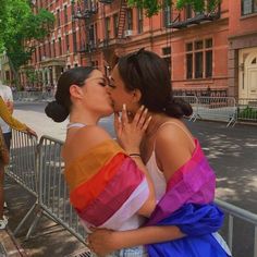 two women kissing each other on the street