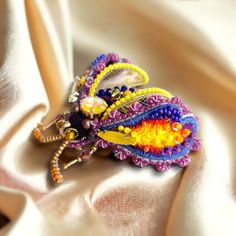 Purple and yellow color beetle brooch is handcrafted by me took hours of precision and elaborate embroidery work. It is glamourized with Swarovski pearls, Czech crystals and beads, embriodered with cotton DMC threads and sequins and it is one of a kind. This handmade brooch is a perfect gift for birthday, anniversary and any special occasions. The brooch will be sent in a nice gift box. Warnings: The embroidered brooch should be kept in a box, away from dust and moisture. Do not get wet, avoid p Yellow Beetle, Elaborate Embroidery, Beetle Brooch, Bug Brooch, Insect Brooch, Embroidery Brooch, Women Embroidery, Embroidered Brooch, Beetle Bug