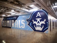 the inside of a building with a sign painted on it's side and a skull in the center