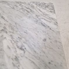 a white marble counter top with grey veining