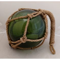 a green glass ball with rope wrapped around it