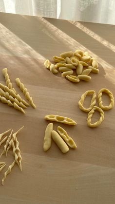 several different types of pasta on a table with one cut in half and the other uncooked