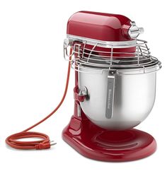 a red mixer sitting on top of a white table