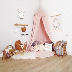 a child's room with pink walls and furniture