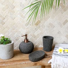 the bathroom is decorated in black and white with yellow flowers on the table next to it