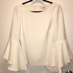 Nwt- Beautiful Badgley Mischka Ivory Top With Flared Bell Sleeves. Perfect Condition. Lovely Top To Pair With A Skirt Or Pants. Fantastic Quality Elegant Cream Blouse For Brunch, Elegant White Blouse For Brunch, Elegant Fitted Cream Blouse, Elegant White Evening Blouse, Elegant Off-white Blouse For Work, Elegant Off White Blouse For Work, Elegant White Party Blouse, Elegant Off White Blouse For Spring, Elegant Fitted Blouse For Cocktail