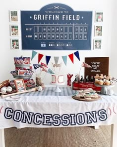 a table topped with baseball themed items and pictures next to a sign that says concesions