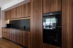 a kitchen with wooden cabinets and black appliances