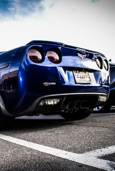 a blue sports car parked in a parking lot