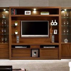 an entertainment center with glass shelves and a flat screen tv mounted on it's side