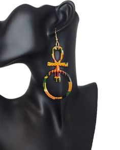 Celebrate your heritage and spirituality with our kente print Ankh Earrings. These exquisite pieces feature the iconic ankh symbol, meticulously hand-painted in stunning detail. Each wooden earring is sealed with a glossy resin finish for lasting beauty and durability. Designed with 925 sterling silver hypoallergenic hooks, they ensure comfort for sensitive ears. Perfect for adding a touch of Afrocentric elegance to any outfit, these earrings are a meaningful and stylish accessory. Embrace your roots and showcase your unique style with our Ankh Earrings! Egyptian Pendant, Ankh Symbol, Afrocentric Earrings, Symbol Of Life, Life Symbol, Wooden Earrings, Stylish Accessories, African Print, Jewelry Earrings Dangle