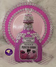 a pink princess noma plate with a tiara on the top and diamonds around it