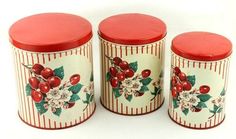 three red and white canisters sitting next to each other