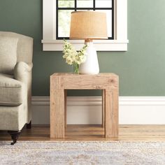 a living room scene with focus on the end table and chair next to the window