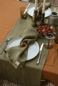 the table is set with plates, silverware, and napkins for two people