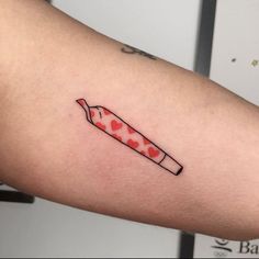 a red and black knife tattoo on the right arm, with hearts in the background