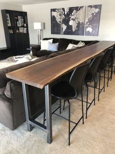 a living room filled with furniture and a large wooden table in front of a couch