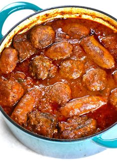 a blue pot filled with meatballs and sauce