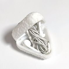 an apple earbud holder is shown on a white surface with wires in it