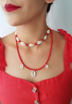 Natural Shell Adjustable Seashell necklace Top Beautiful choker necklace ♥ White color natural shells (with 10 pieces natural cowrie ) ( shells). coral color seed bead ♥min lenght 13 inch ---- max lenght 28 inch ♥ Coral color seed bead necklace 1 big-2 small cowrie- 21 inch ♥Can be worn in different lengths to fit your each time needs. Adjustable closure that tightens and looses with ease for the perfect fit. Just pull the endings and the necklace will close on the length you wish. ♥min lenght 1 Handmade Cowrie Shell Choker For Summer, Summer Handmade Cowrie Shell Choker, Dainty Shell Necklace For Summer Beach, Dainty Shell Necklace For Beach, Red Beach Choker Jewelry, Handmade Strand Choker For Summer, Trendy Handmade Shell Jewelry, Handmade Red Choker For Beach, Festival Cowrie Shell Choker