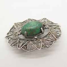 925 Sterling Silver Vintage Turquoise Gem Filigree Pin Brooch / Pendant Weight: 9.5g WELCOME TO PAWN SHOP We are an actual pawn shop and have been in business for over 25 years. Since 1990, our establishment has been serving a variety of clients by providing them with short term cash solutions and options of liquidity regarding their treasured heirlooms. Acknowledging that today′s customers are very sophisticated and are looking for a variety of investments, our acquisitions are hand-picked for Vintage Silver Brooch With Gemstone, Vintage Silver Gemstone Brooch, Sterling Silver Green Brooch, Green Sterling Silver Brooch, Green Sterling Silver Brooch Jewelry, Green Gemstone Pendant Brooches, Antique Green Gemstone Brooches, Green Sterling Silver Brooches For Gifts, Green Sterling Silver Brooch For Gift