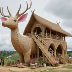 people are standing in front of a building made to look like a deer