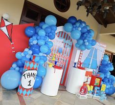 blue and white balloons are on display at a birthday party