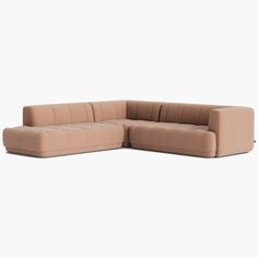 the corner sofa is made out of fabric and has a rounded backrest, with an extended