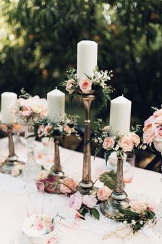 a table with candles and flowers on it