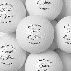 a pile of white golf balls with the names and date printed on them in black ink