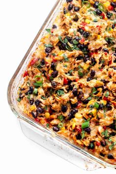 a casserole dish filled with chicken, black beans and corn