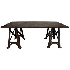 an old wooden table with metal legs