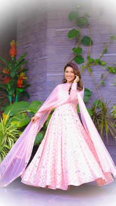 a woman in a pink and white gown