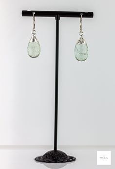 These pretty Silver Leafed Seafoam Green Prasiolite Drop Earrings from Miel Jewelry Shop are a lovely addition to your jewelry collection. They feature sterling silver lever backs that support a big beautiful, dimensional seafoam green prasiolite gemstone. The unique leaf design adds a touch of elegance and sophistication to the large natural prasiolite drop. Sparkling, faceted silver-leafed, light seafoam green, pear-shaped prasiolite drops. Sterling silver lever backs for a secure and comforta Light Seafoam Green, Statement Earrings Silver, Boho Chic Jewelry, Gemstone Jewelry Handmade, Chic Jewelry, Green Amethyst, Raw Gemstones, Seafoam Green, Amethyst Gemstone