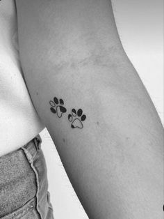 a woman's arm with two paw prints on the left side of her arm