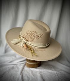 A SandalwoodandBirchCo custom item. Felt hat in creamy vanilla with burned detailing. Perfect hat for a boho, western wedding or to dress up your cute fit. Hat comes with adjustable head band. Send DM for customization. Fitted Country Style Cream Hat, Fitted Beige Felt Hat For The Beach, Handmade Adjustable White Felt Hat, White Handmade Bohemian Felt Hat, Adjustable Cream Felt Hat For Country Events, Country Style Cream Hat Band For Festivals, Country Style Cream Hat Bands For Festivals, Bohemian Felt Hat For Summer, Bohemian Fitted Felt Hat For Summer