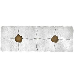 a white stone wall with three holes in it