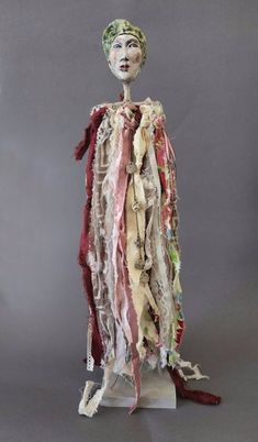 a woman's head is made out of fabric and other things that are on display