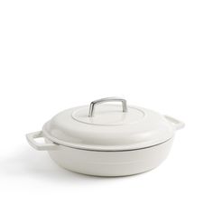 a white casserole dish with a handle on the top and bottom, sitting against a white background