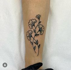 a black and white flower tattoo on the leg