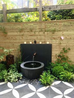 an outdoor fountain in the middle of a garden