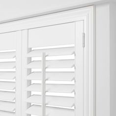 the shutters are closed to let in light on the room's white walls