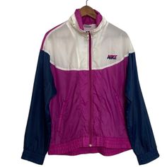 This vintage Nike jacket is in good condition! A classic lightweight windbreaker track jacket with a stow away hood and zip front Ventilated mesh back yoke and two pockets. Colorblock blue purple pink and white with Nike logo on chest. Tag appears to be 1980s Made in Korea 100% nylon Size medium See pics for measurements. Condition note: no stretch in elastic Retro Pink Windbreaker For Streetwear, Pink Retro Windbreaker For Streetwear, Retro Pink Hooded Windbreaker, Pink Retro Hooded Windbreaker, 90s Pink Windbreaker For Streetwear, Retro Pink Windbreaker, Pink Nylon Windbreaker For Streetwear, Sporty Purple Nylon Windbreaker, Retro Purple Windbreaker For Streetwear