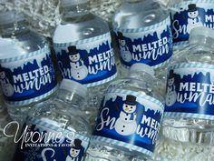 there are many bottled water bottles with snowman designs on the top one is blue and white