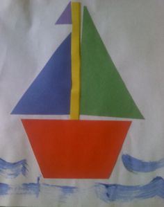 a paper bag with a colorful sailboat on it's side in the water