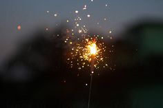 a sparkler is lit up in the night sky