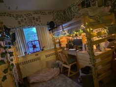 a bedroom with bunk beds and desks in the corner, next to a window